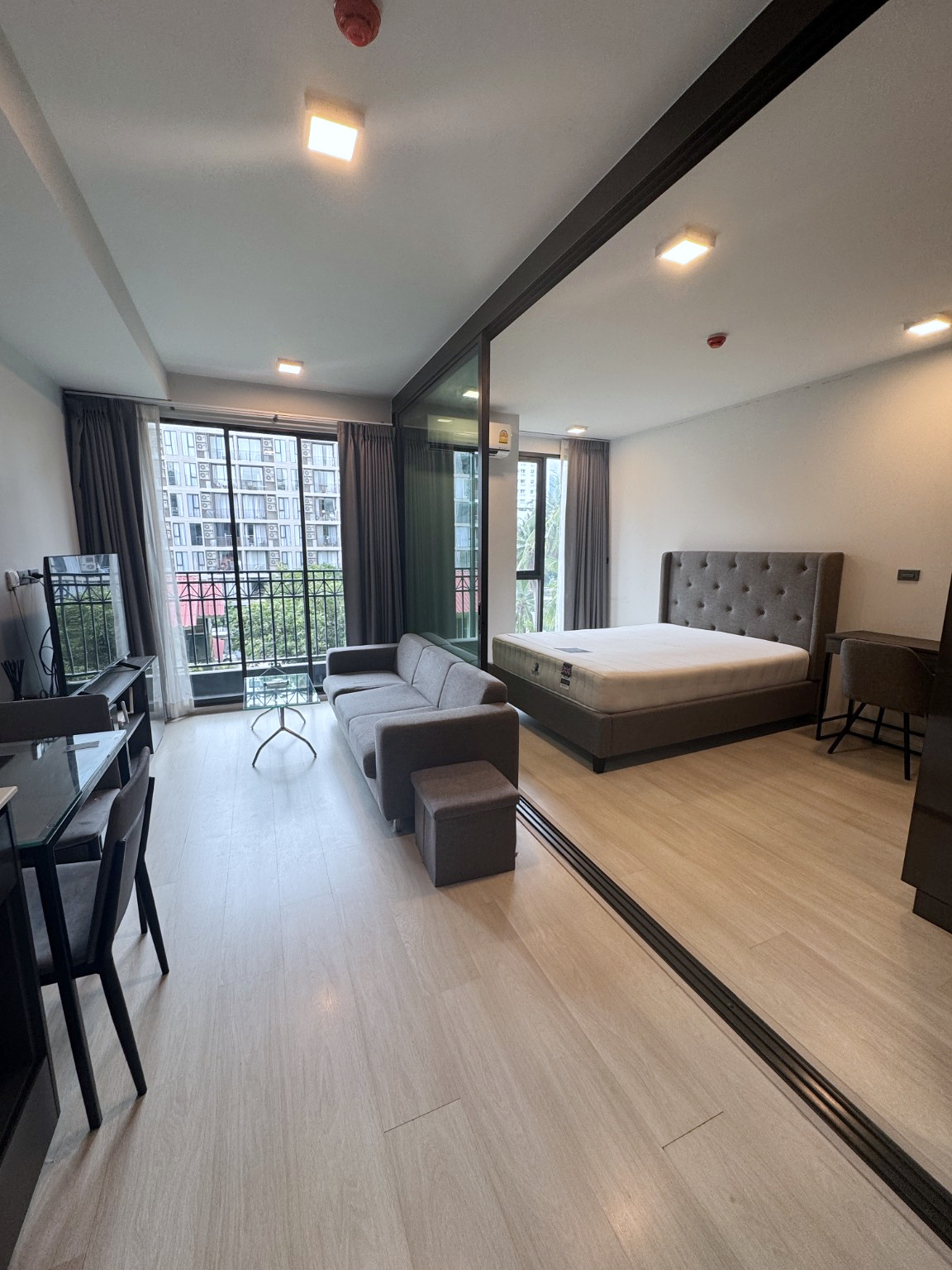 Open-plan living area and bedroom at Venio Sukhumvit 10